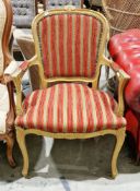 French open armchair in the Louis XV manner with a gilded finish, green and red striped