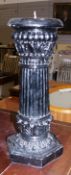 Pair of black painted candlesticks of exaggerated portions in the classical-style, a pair of