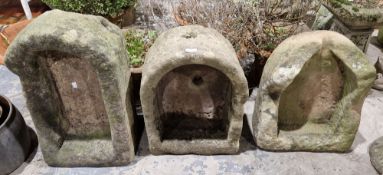Three 19th century stone sinks, each with one rounded end, largest 25cm high x 59cm long
