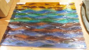 Stained wave-moulded contemporary glass wall plaque, coloured in graduating rainbow tints, with