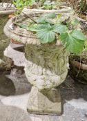Two similar composite stone garden urns of campana form, each with moulded decoration of Roman