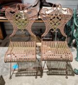 Pair of vintage painted metal folding garden chairs, each with pierced shield-shaped scroll back,