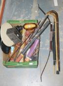 Collection of vintage umbrella and walking canes, a carved wooden Indonesian bow and arrow, an