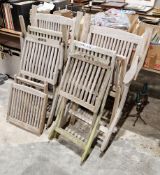 An assembled set of weathered teak garden furniture, including a pair of folding chairs,  labelled