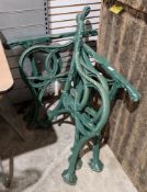 Pair of early 20th century Victorian style green-painted scroll-shaped bench ends and two table base