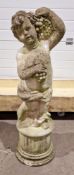 Weathered cast composite stone garden statue of a bacchic putto holding grapes on a fluted column