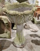 Composite stone garden urn on stand, the top moulded in the form of a flower, 81cm high x 50cm