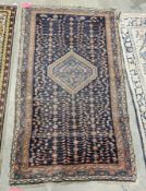 Eastern midnight blue rug with central hooked lozenge on geometric ladder pattern field, multiple