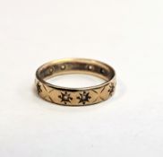 9ct yellow gold eternity ring set with small clear stones within engraved stars, size N, approximate