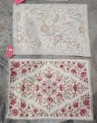 Two tapestry rugs, one cream ground with central lozenge on floral field, single blue border, 87cm x