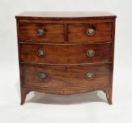 Early 19th century mahogany bowfront chest comprising two short and two long cockbeaded drawers with