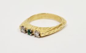 18ct gold, emerald and diamond three-stone ring in modern setting, the shank with bark-finish, maker