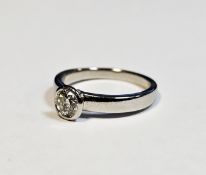 Platinum solitaire diamond ring the circular stone in rubover setting, 0.35-0.40ct approx., size H/I