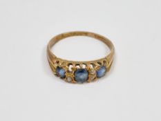18ct yellow gold, sapphire and diamond ring, claw-set with a row of three round old cut sapphires