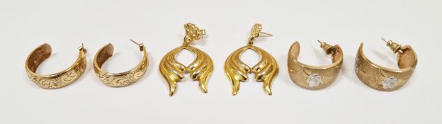 Two pair of 9ct yellow gold loop earrings, one pair with silver flower inlay and textured finish and