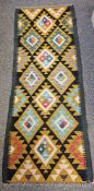 Maimana Kilim black ground runner with one row of four hooked lozenges and two rows of three