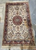 Eastern cream ground rug with central floral circular medallion on floral field, multiple floral