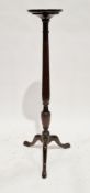 19th century mahogany torchere, the circular top with moulded edge, on a turned tapered fluted and