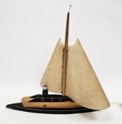 Art Deco-style oak and ebonised table lamp in the form of a sailing boat with celluloid shade sails,