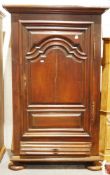 19th century continental walnut cupboard, the moulded cornice over panelled sides and a single