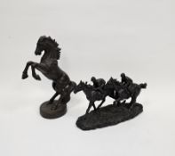 Cast iron model of a rearing horse, 29cm high and a bronzed resin model of two racehorses with
