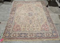 Large peach ground rug with central hooked lozenge on floral field, floral spandrels and multiple