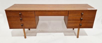 Mid-century teak dressing table by Avalon, comprising an arrangement of seven drawers, six having