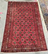 Persian Belouch red ground rug decorated with rows of guls within a border, 200cm x 140cm