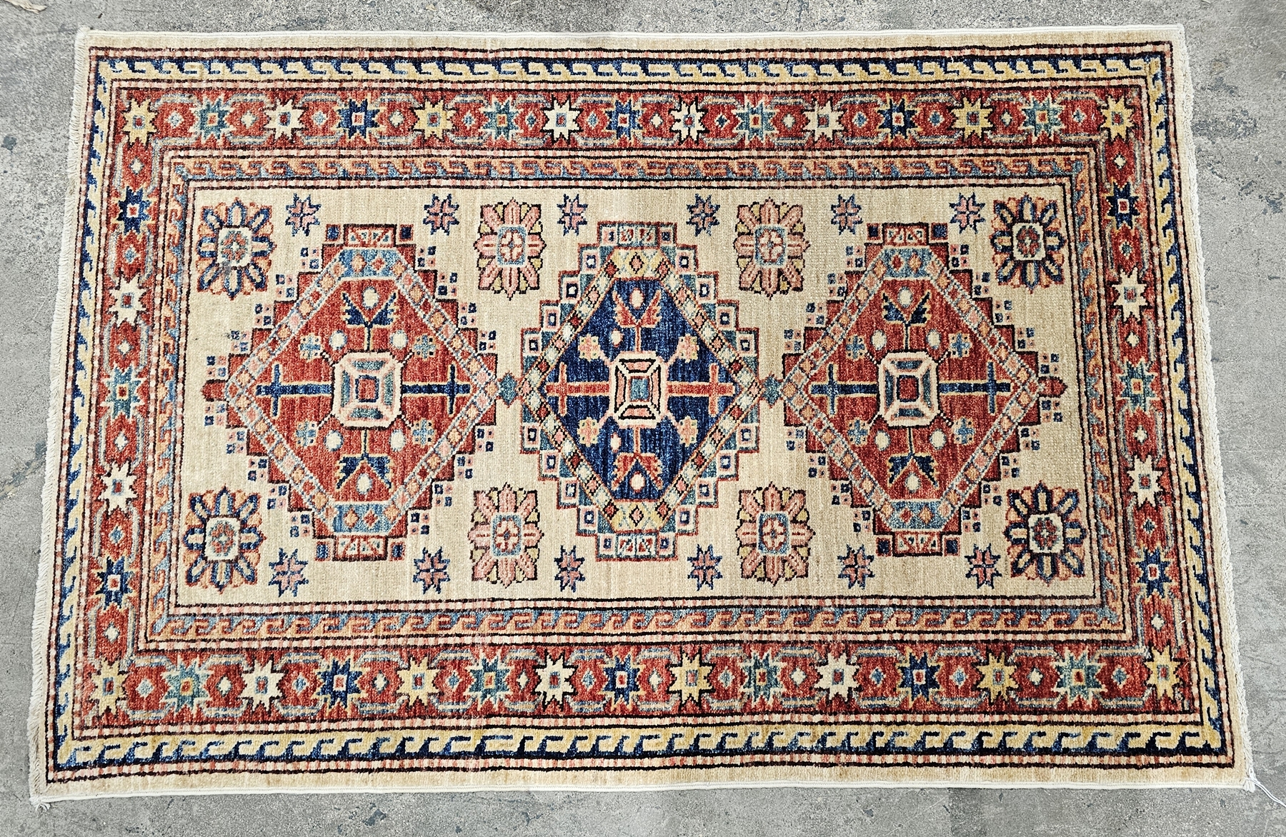 Two small Kazak rugs decorated with geometric patterns within a border, each 121cm x 81cm (2) - Image 2 of 2