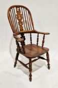 19th century elm and ash comb back windsor elbow chair with pierced shaped splat, on turned baluster