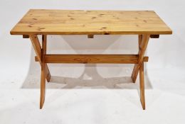 Modern pine dining table, the rectangular top on a X-frame trestle-style base, 75cm high x 121cm