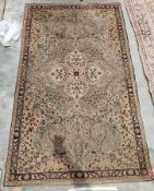 Persian style green ground rug with central floral medallion on floral field, floral spandrels and