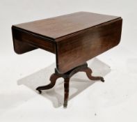 Early 19th century mahogany drop-flap table with drawer to one end, on a ringed turned pedestal