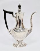 Sterling silver coffee pot, of fluted oval baluster form with ebony finial and handle, on oval
