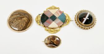 Victorian yellow metal mourning brooch in the Etruscan style with a domed banded agate centre and