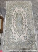 Cream ground silk rug with single floral medallion, multiple floral and single herati border,
