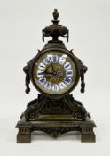 Late 19th/early 20th century French bronze mantel clock, urn finial with lion's head handles, the
