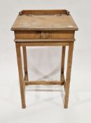 Early 20th century pine child's desk with sloping lift lid writing surface, on square legs with a