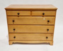 Modern lacquered pine chest of two short over three long drawers with metal knob handles, on bracket