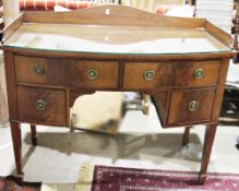 19th century mahogany bow fronted washstand, with three-quarter back rail over an arrangement of