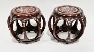 Pair of Chinese hardwood barrel-shaped stools with mother-of-pearl inlay depicting flowers and
