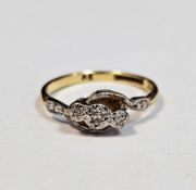 18ct yellow gold, platinum and diamond cross-over ring, with three pave set diamonds, size M,