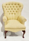 Modern buttonback armchair upholstered in yellow fabric, on wooden cabriole legs, 92cm high x 68cm