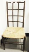 In the manner of William Birch a lattice back low chair with rush seat, on turned legs with double