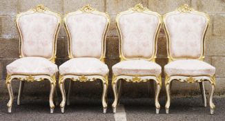 Set of four dining chairs in the French Louis XV manner, the gilt and white painted frames carved