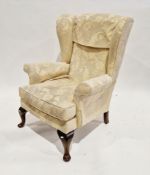 Mid-century Parker Knoll wingback armchair upholstered in a yellow jacquard fabric, on cabriole