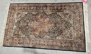 Persian style silk blue ground rug with central floral medallion, floral spandrels, multiple
