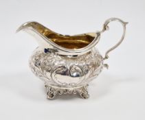 George IV silver cream jug, London 1836, makers mark rubbed, of squat baluster form with embossed