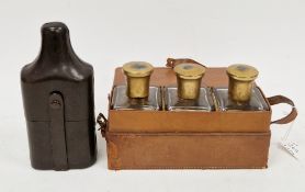 Early 20th century leather cased gentleman's bottle set, the three square glass bottles with gilt