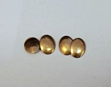 Pair of 15ct hallmarked yellow gold cufflinks, the plain double oval heads united by chains,